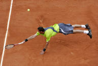 FILE - In this May 30, 2007, file photo, Russia's Marat Safin reaches for the ball as he plays Serbia's Janko Tipsarevic in their second round match of the French Open tennis tournament at Roland Garros stadium in Paris. (AP Photo/Lionel Cironneau, File)