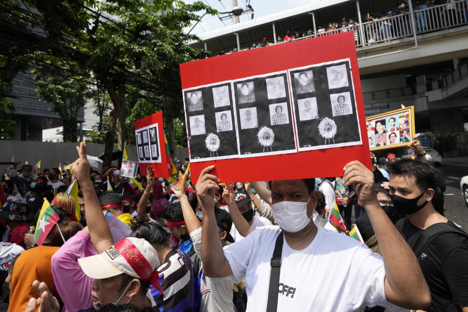 Myanmar nationals living in Thailand hold the pictures of the executed political prisoners in Myanmar, as they protest outside Myanmar's embassy in Bangkok, Thailand, Tuesday, July 26, 2022. International outrage over Myanmar's execution of four political prisoners intensified Tuesday with grassroots protests and strong condemnation from world governments, as well as fears the hangings could derail nascent attempts to bring an end to the violence and unrest that has beset the Southeast Asian nation since the military seized power last year.(AP Photo/Sakchai Lalit)