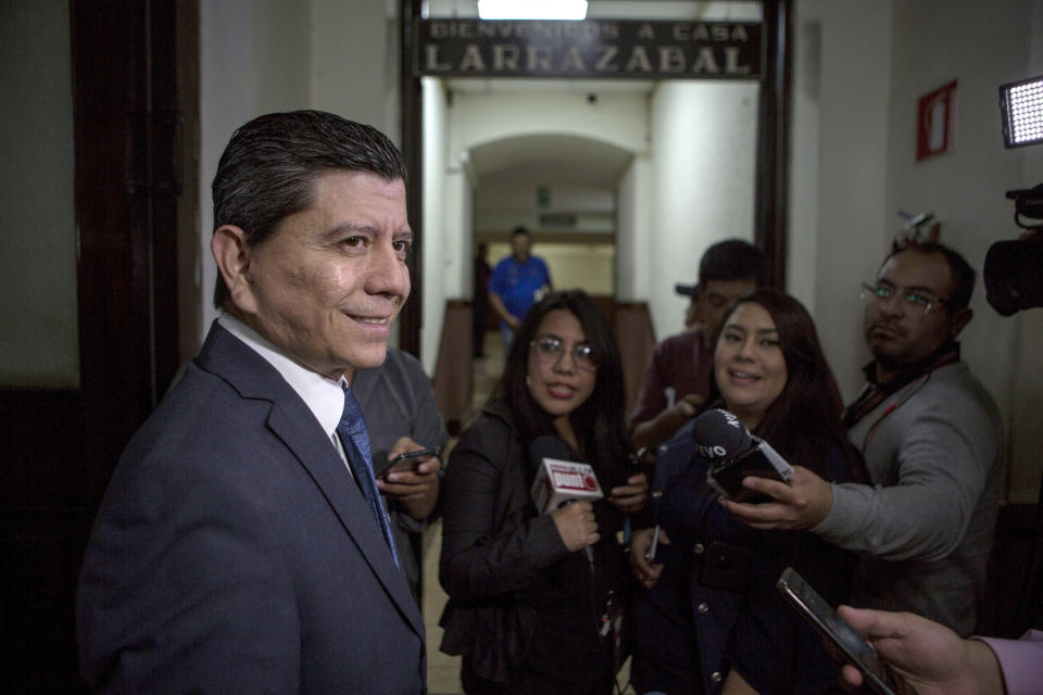 Guatemalan congressman Juan Ramon Lau, answers questions from journalists before starting a session of Congress in Guatemala City, Wednesday, Dec. 11, 2019. Lau is presiding over the commission that is investigation the U.N.-sponsored anti-graft commission, CICIG, and said it has heard from more than 20 people who say they were victimized by CIGIC and about 40 are expected to appear before it wraps up. (AP Photo/Oliver de Ros)