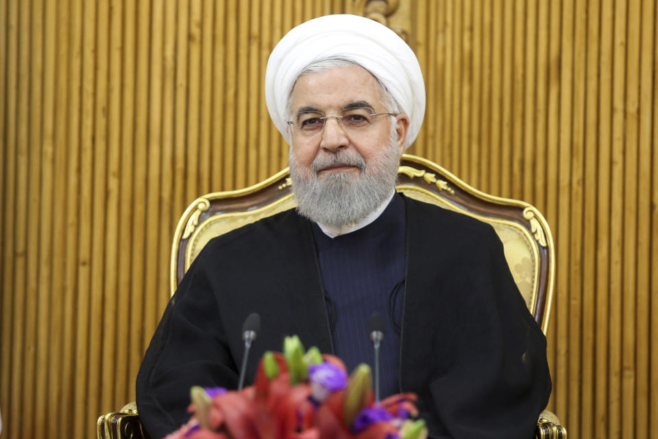 In this photo released by the official website of the office of the Iranian Presidency, President Hassan Rouhani sits at the Mehrabad airport pavilion before leaving Tehran, Iran, for New York to attend United Nations General Assembly, Monday, Sept. 23, 2019. Rouhani, before traveling to attend the U.N. meetings, said Monday that Iran will invite "all littoral states of the Persian Gulf" to join its coalition "to guarantee the region's security." (Iranian Presidency Office via AP)