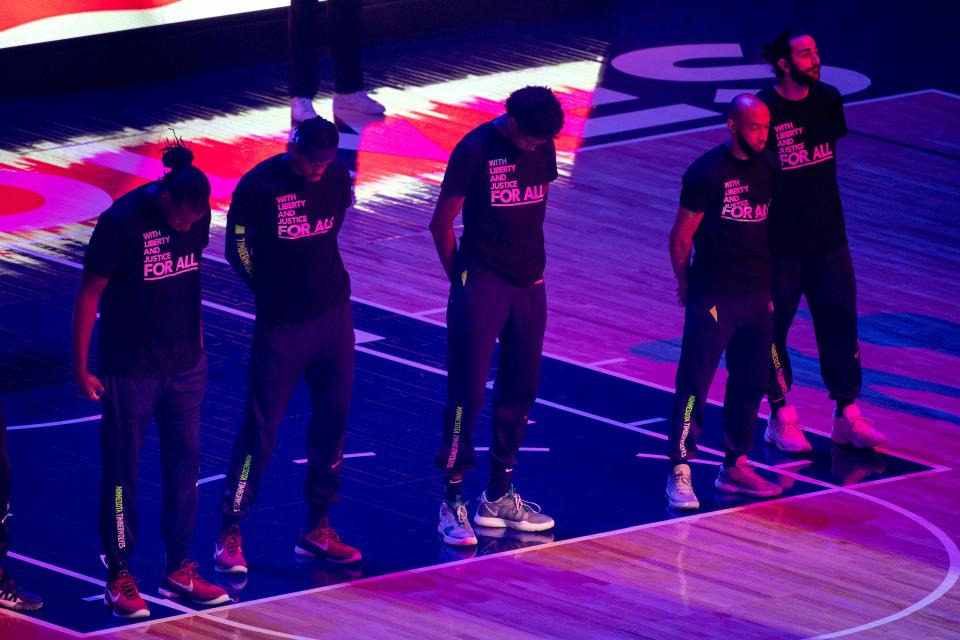 Members of the Minnesota Timberwolves wear T-shirts that read "With liberty and justice FOR ALL" as a tribute to Daunte Wright before their game against the Brooklyn Nets.