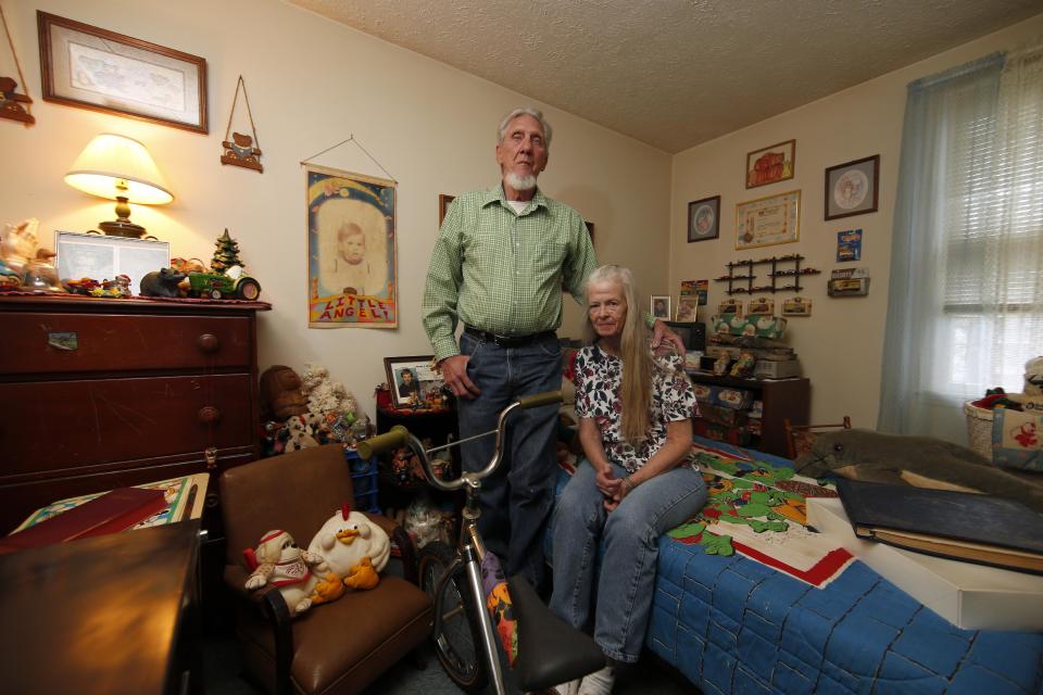 This photo taken April 29, 2014, shows Victor Shoemaker Sr., and his wife Nettie Shoemaker posing for a photograph in their son's bedroom in their home in Leesburg, Va. The bedroom has been left the way it was when twenty years ago Victor Dwight Shoemaker Jr., vanished while playing with two cousins along a West Virginia mountainside, his parents hold the belief that their only child is still alive. The boy known as J.R. had been in the woods behind his grandfather's mobile home in Hampshire County when two cousins emerged without him on May 1, 1994. No trace of him was ever found. (AP Photo/Alex Brandon)