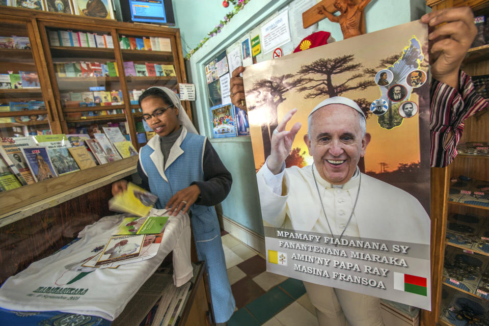A nun browses in a store with Pope paraphernalia in Antananarivo, Madagascar, Tuesday, Sept. 3, 2019. Pope Francis heads this week to the southern African nations of Mozambique, Madagascar and Mauritius, visiting some of the world's poorest countries that have been hard-hit by some of his biggest concerns: conflict, corruption and climate change. (AP Photo/Alexander Joe)