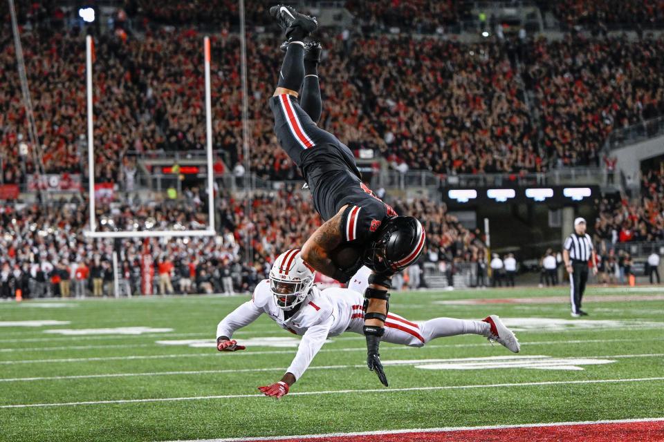 Ohio State tight end Cade Stover scores a touchdown after being upended by Badgers cornerback Jay Shaw during the first quarter Saturday night.