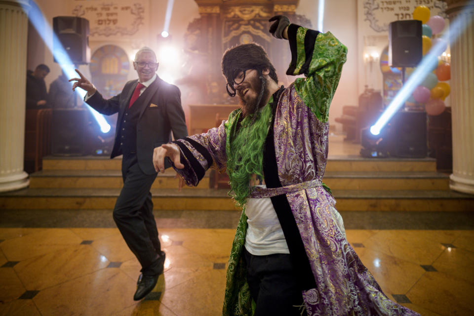 Men of the Ukrainian Jewish community dance during Purim celebrations and a festive meal at the Great Choral Synagogue in Kyiv, Ukraine, Sunday, March 24, 2024. (AP Photo/Vadim Ghirda)