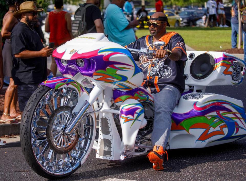 Roddney Rich rides one of his several custom creations outside Hooters at the Myrtle Beach Mall on Friday.  He and his wife drove from North Carolina in two custom green Harley-Davidson motorcycles.  The 2024 Black Pearl Cultural Heritage and Bike Festival, also known as Black Bike Week, came roaring to the north end of the Grand Strand on Friday evening.  Motorcyclists gathered at the Myrtle Beach Mall to show off their rides, rode through Atlantic Beach and partied beneath beach houses in North Myrtle Beach.  SC May 24, 2024.