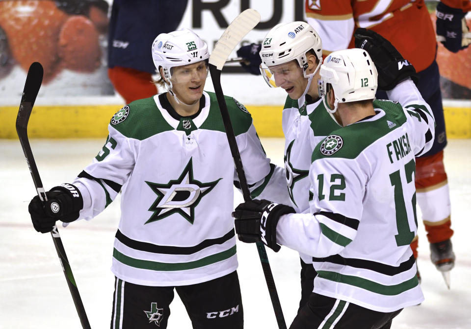 Dallas Stars defenseman Esa Lindell (23) celebrates a goal with teammates Joel Kiviranta (25) and Radek Faksa (12) during the third period of an NHL hockey game against the Florida Panthers on Wednesday, Feb. 24, 2021, in Sunrise, Fla. (AP Photo/Jim Rassol)