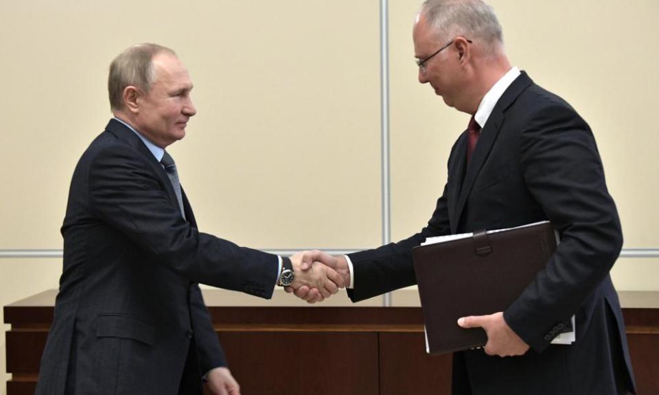 Kirill Dmitriev (right) shaking hands with the Russian president, Vladimir Putin, in January.