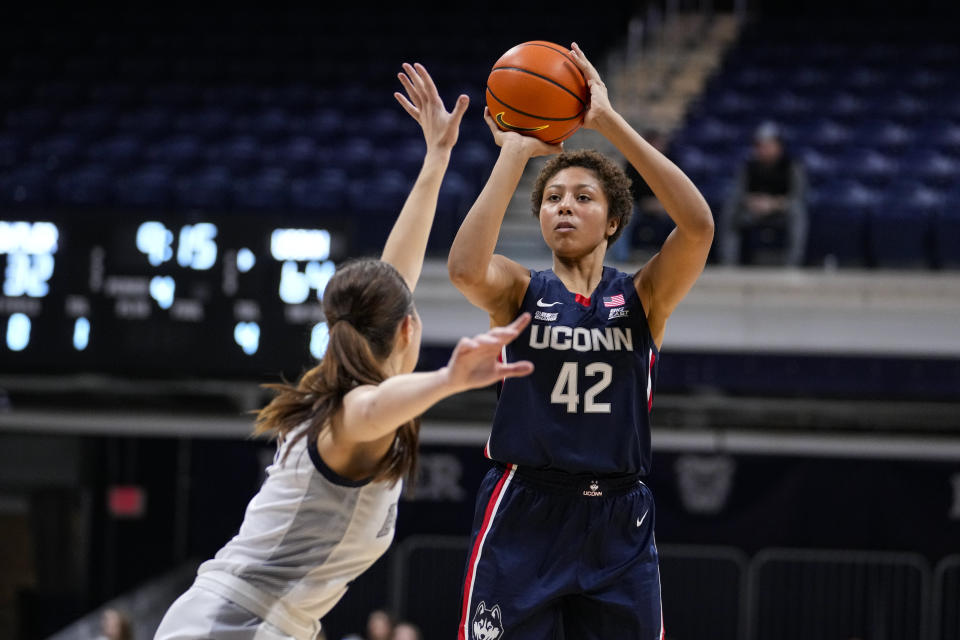 UConn forward Amari DeBerry (42) shoots over Butler guard Tenley Dowell (11) during the second half of an NCAA college basketball game in Indianapolis, Tuesday, Jan. 3, 2023. (AP Photo/Michael Conroy)