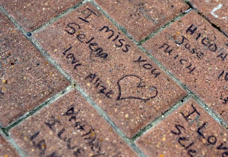 Messages are left by fans on bricks March 31, 2015, at the Selena Memorial Statue. Fans gathered for a moment of silence in remembering the Latin pop star Selena Quintanilla Perez during the 20th anniversary of the death.