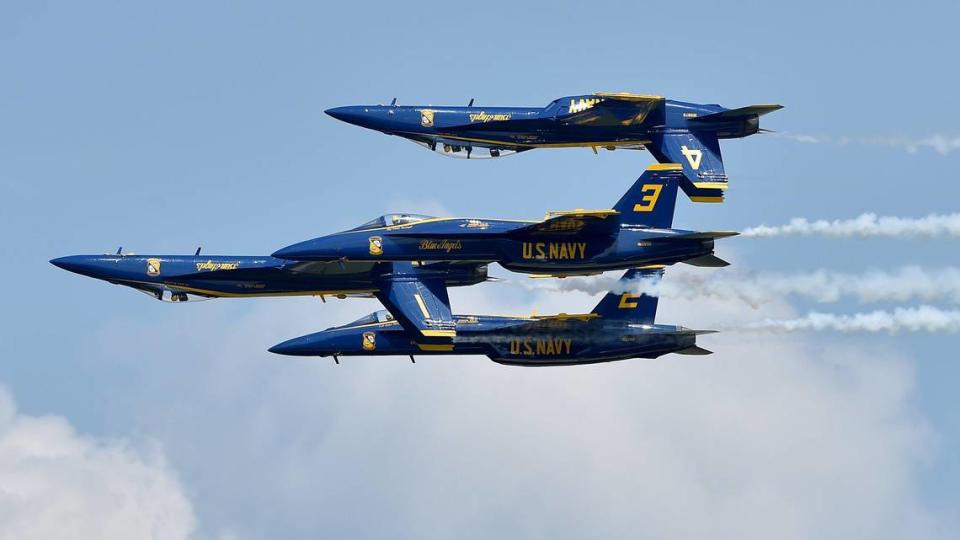 Two pilots from the United States Navy Blue Angels fly inverted as two others fly in a tight formation with them on the second and final day of the 2021 Kansas City Airshow at the New Century AirCenter in New Century, Kansas, Sunday, July 4, 2021.