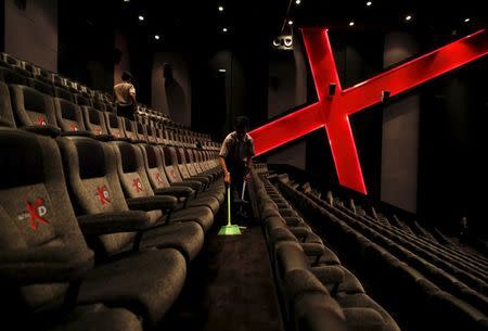 An employee at a Cinemaxx theatre cleans up between screenings in Lippo Karawaci, near Jakarta, Indonesia February 17, 2016. REUTERS/Darren Whiteside