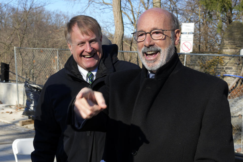 Pennsylvania Governor Tom Wolf, right, and Allegheny County Executive Rich Fitzgerald attend a dedication ceremony for the rebuilt Fern Hollow Bridge in Pittsburgh on Wednesday, Dec. 21, 2022. The original bridge collapsed during a snow storm on Jan. 28, 2022. The collapse of the Fern Hollow Bridge became a symbol of the country's troubled infrastructure. (AP Photo/Gene J. Puskar)