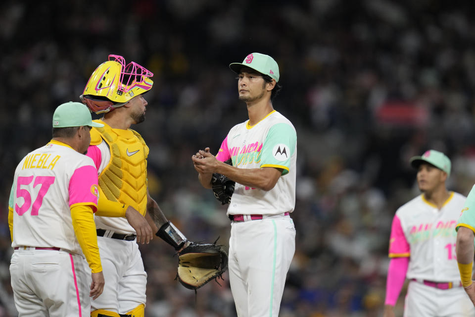 San Diego Padres starting pitcher Yu Darvish, center, meets with pitching coach Ruben Niebla (57) and catcher Gary Sanchez, second from left, for a mound visit during the fifth inning of a baseball game against the New York Mets, Friday, July 7, 2023, in San Diego. (AP Photo/Gregory Bull)