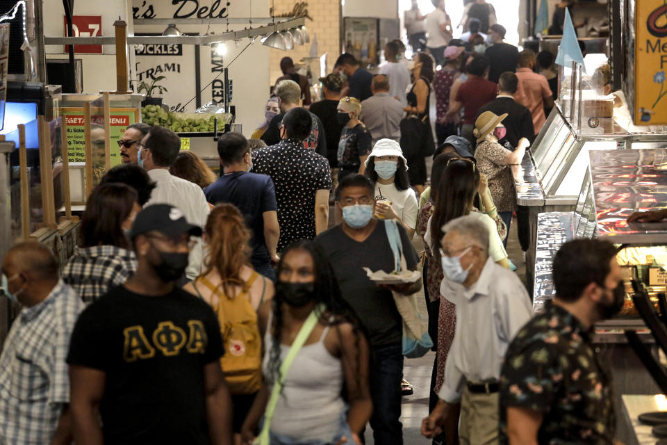 People, many masked, look for lunch at the Grand Central Market in downtown Los Angeles on June 15, 2021. (Genaro Molina / Los Angeles Times via Getty Images)