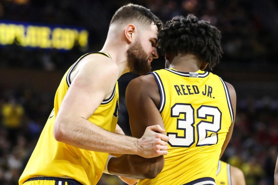 Michigan center Hunter Dickinson talks to forward Tarris Reed Jr. to celebrate a play against Wisconsin during the second half of U-M's 87-79 overtime win on Sunday, Feb. 26, 2023, at Crisler Center.