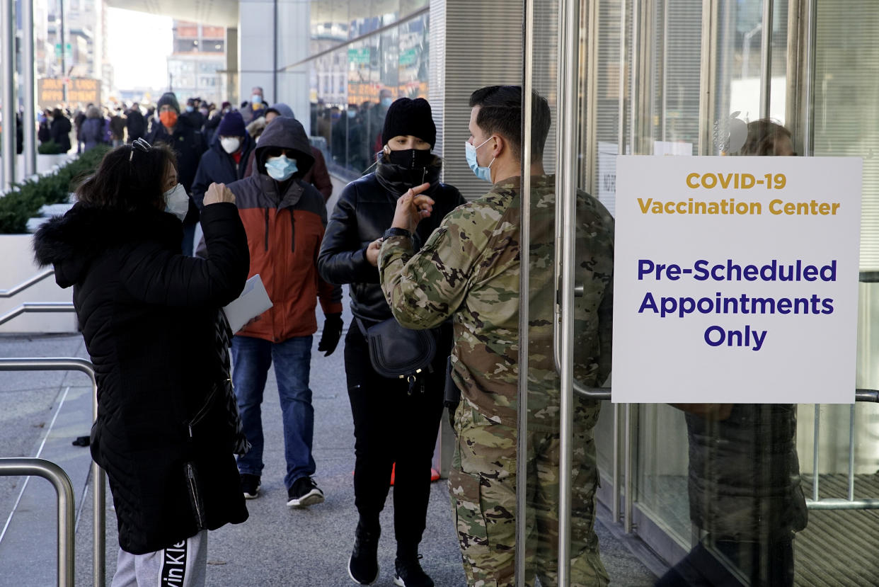 There are financial and psychological costs to getting a COVID-19 vaccine that employers can make easier &mdash; or harder &mdash; for their workers. Above, people wait to enter the Javits Center in New York City to receive a vaccine in March. (Photo: VIEW press via Getty Images)