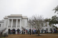 People wait outside of the courthouse to get a seat at the double murder trial of Alex Murdaugh at the Colleton County Courthouse in Walterboro, S.C., Friday, Feb. 3, 2023. The 54-year-old attorney is standing trial on two counts of murder in the shootings of his wife and son at their Colleton County home and hunting lodge on June 7, 2021. (Andrew J. Whitaker/The Post And Courier via AP, Pool)