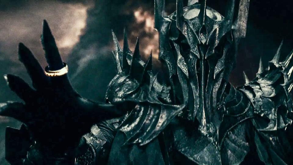 Sauron dressed in armor wears the One Ring during battle in a scene from The Lord of the Rings: The Fellowship of the Ring.