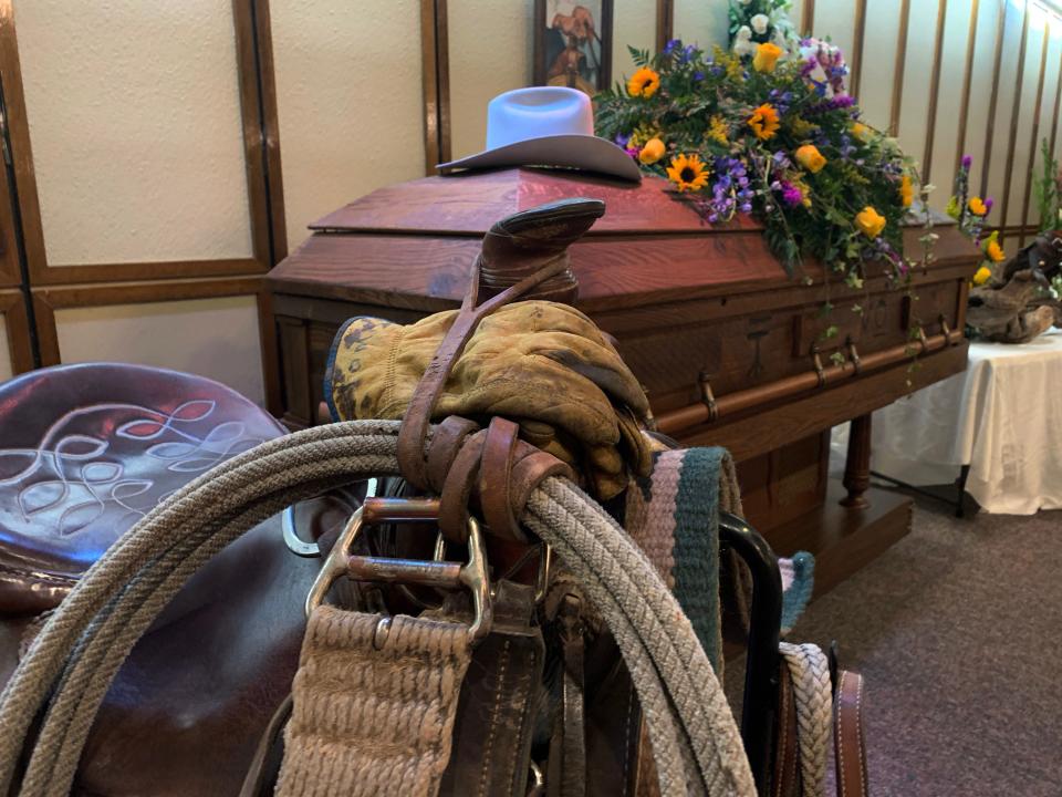 A cowboy hat along with a saddle, gloves and rope are arranged at a funeral in Las Cruces, N.M. on Friday, Nov. 6, 2020.