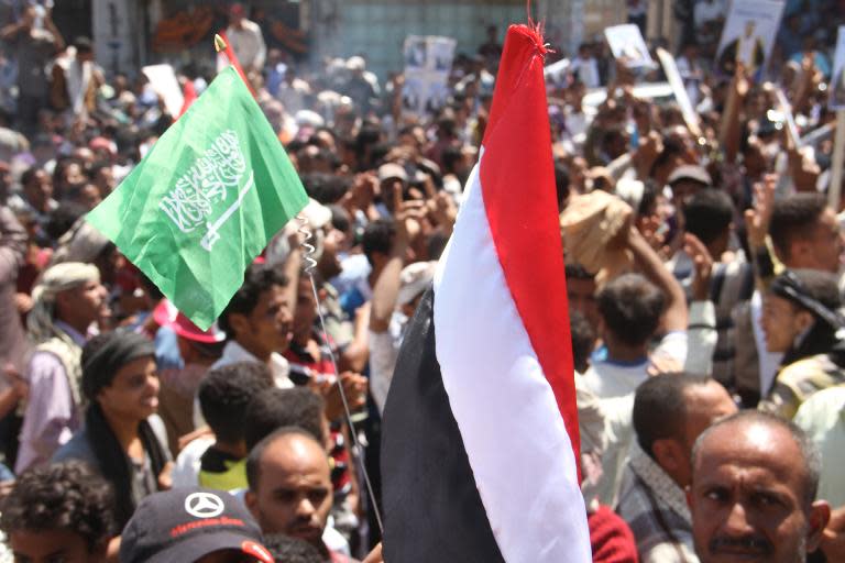 Yemenis wave their national flag along with the Saudi national flag during a demonstration in the strategic city of Taez on March 26, 2015, in support of the Saudi-led 'Firmness Storm' operations against Shiite rebels