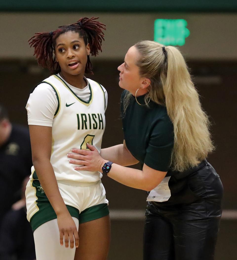 STVM girls basketball coach Carley Whitney has a word with guard Erica King during the first half of a high school basketball game against Brush, Wednesday, Jan. 31, 2024, in Akron, Ohio.