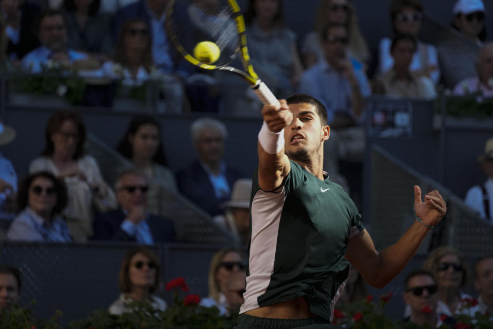 Carlos Alcaraz, of Spain, returns the ball to Alexander Zverev of Germany during the final match at the Mutua Madrid Open tennis tournament in Madrid, Spain, Sunday, May 8, 2022. (AP Photo/Paul White)