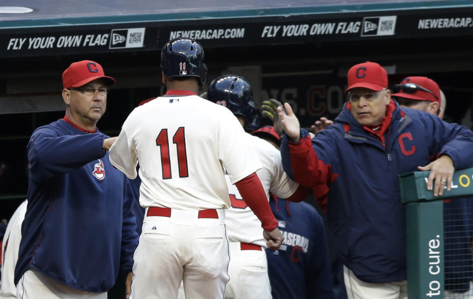 Cleveland Indians' Jose Ramirez, center, is congratulated by manager Terry Francona, left, and teammates after scoring on a sacrifice fly by Nick Swisher in the fifth inning of a baseball game against the Chicago White Sox, Saturday, May 3, 2014, in Cleveland. (AP Photo/Tony Dejak)