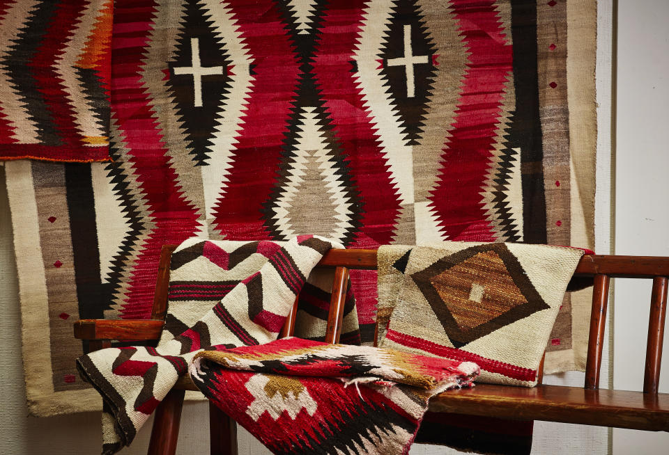 This photo provided by Upstate Rug Supply shows a selection of Navajo rugs. "The Navajo are among the finest rug makers in the world, featuring loom work and design on par with the best Persian rugs," says Atlanta-based design editor Leanne Potts. "These Southwestern masterpieces feature designs and colors that work with many decor styles." Joanna Mahserdjian, founder of Upstate Rug Supply in Hudson, NY, agrees. "Hang one on the wall as art, place one on the floor in a mid-century modern home, or layer them with Persian rugs- as Ralph Lauren does. (Christian Harder/Upstate Rug Supply via AP)