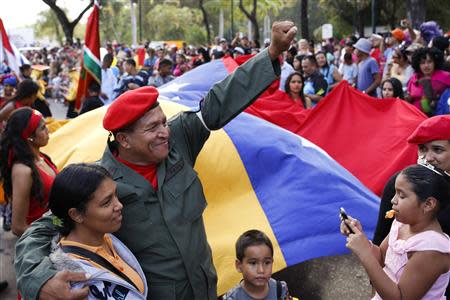 A man dressed as late Venezuelan President Hugo Chavez waves during the Carnival festival in Caracas March 4, 2014. REUTERS/Carlos Garcia Rawlins