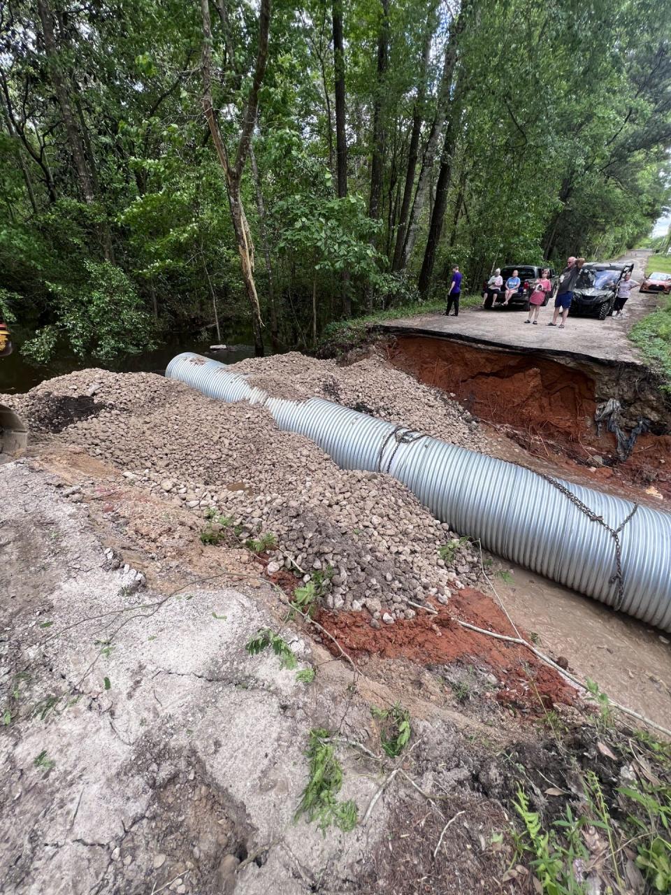 County staff work to fix Sir Richard Road after a portion of it was washed away by a heavy storm which hit the Big Bend Wednesday night.