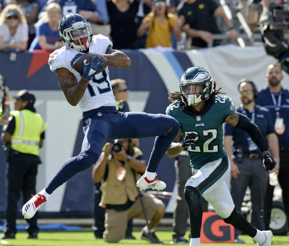 <p>Tennessee Titans wide receiver Tajae Sharpe (19) catches a touchdown pass in front of Philadelphia Eagles cornerback Sidney Jones (22) in the second half of an NFL football game Sunday, Sept. 30, 2018, in Nashville, Tenn. (AP Photo/Mark Zaleski) </p>