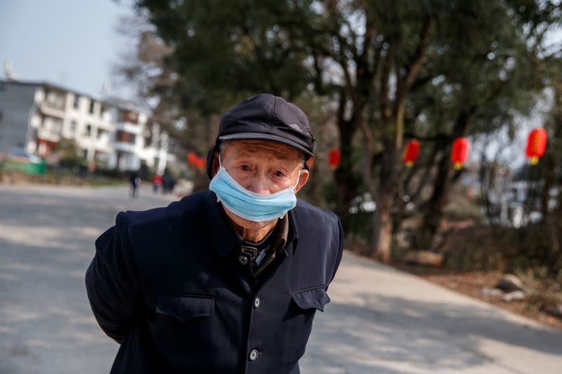 Man wears a face mask in a village outside Donglin Temple that is under lockdown because of the coronavirus outbreak in Jiujiang