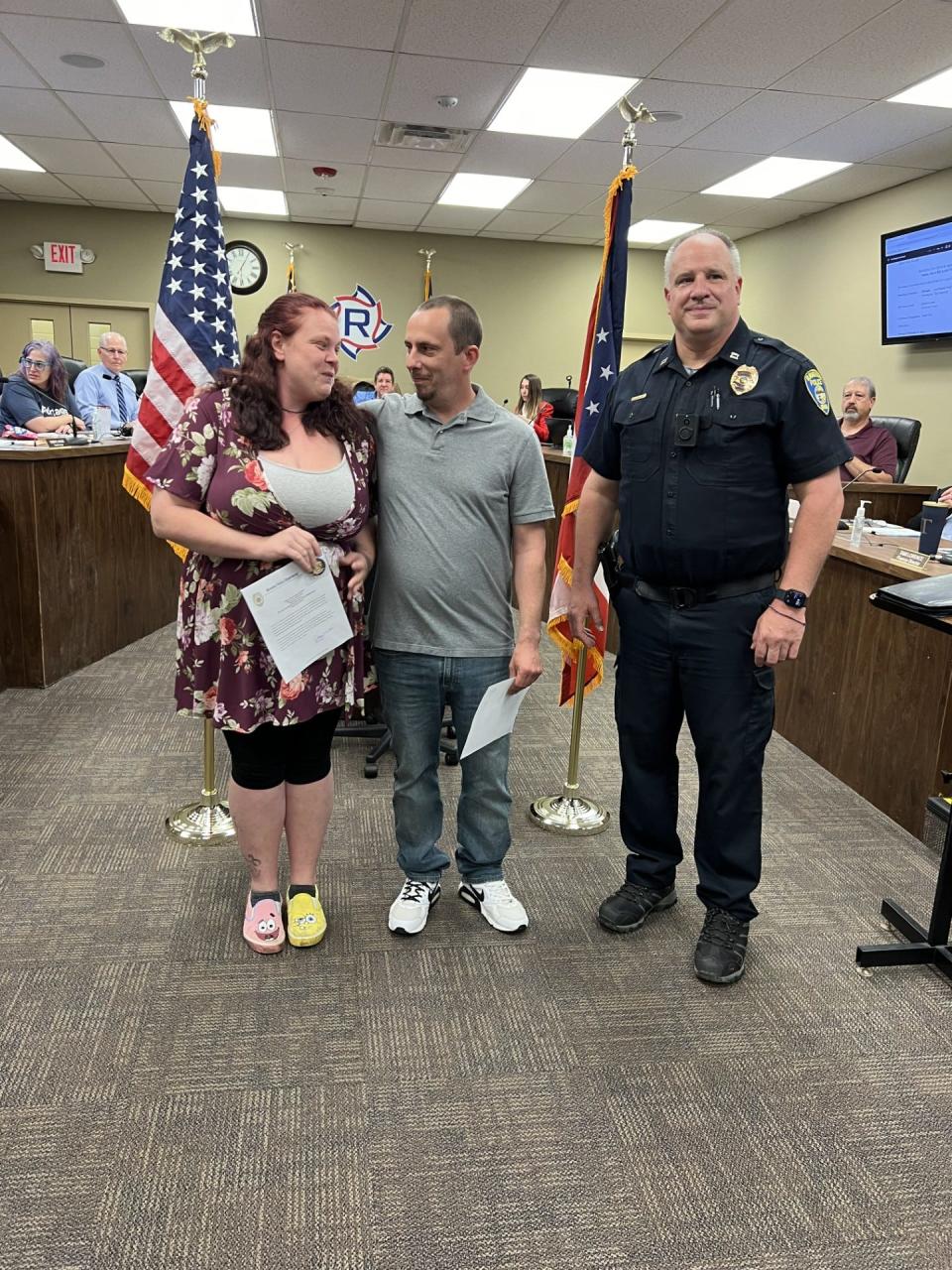 Brittanie Larson and Christopher Taylor were presented with Lifesaving Awards for their work in evacuating their neighbors after a fire at their Hazen Street apartment building. From left are Larson, Taylor and Capt. Jake Smallfield.