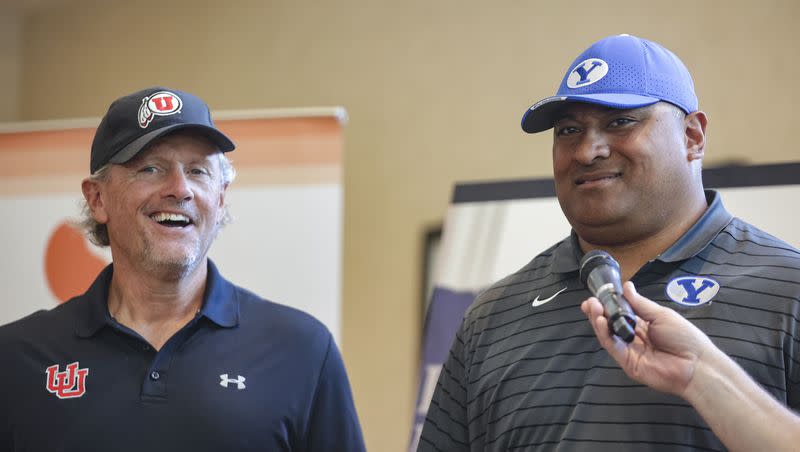 Utah Utes football head coach Kyle Whittingham and BYU football head coach Kalani Sitake react to a question during a ceremony for the Coaches Legacy Golf Invitational at Hidden Valley Country Club in Sandy on June 6, 2022.