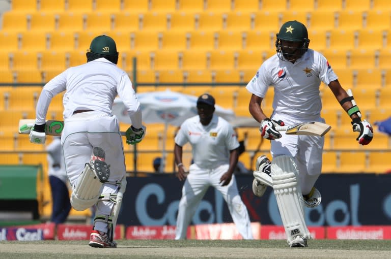Harris Sohail (R) and Muhammad Abbas of Pakistan run between the wickets during a Test match against Sri Lanka, at Sheikh Zayed Stadium in Abu Dhabi, on October 1, 2017