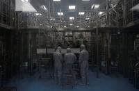 Employees in PPE work inside a lab where the HPV vaccine is produced at the Serum Institute of India, in Pune