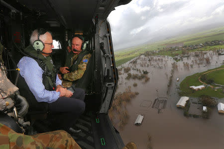 Australian Prime Minister Malcolm Turnbull looks at damaged and flooded areas from aboard an Australian Army helicopter after Cyclone Debbie passed through the area near the town of Bowen, located south of the northern Queensland town of Townsville in Australia, March 30, 2017. REUTERS/Gary Ramage/Pool