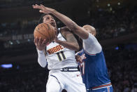 Denver Nuggets guard Monte Morris (11) goes to the basket past New York Knicks forward Taj Gibson (67) during the first half of an NBA basketball game Thursday, Dec. 5, 2019, at Madison Square Garden in New York. (AP Photo/Mary Altaffer)