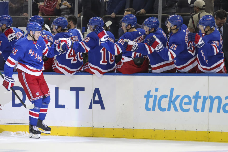 New York Rangers right wing Kaapo Kakko (24) celebrates at the bench after scoring a goal against the Edmonton Oilers during the first period of an NHL hockey game, Saturday, Oct. 12, 2019, at Madison Square Garden in New York. (AP Photo/Mary Altaffer)