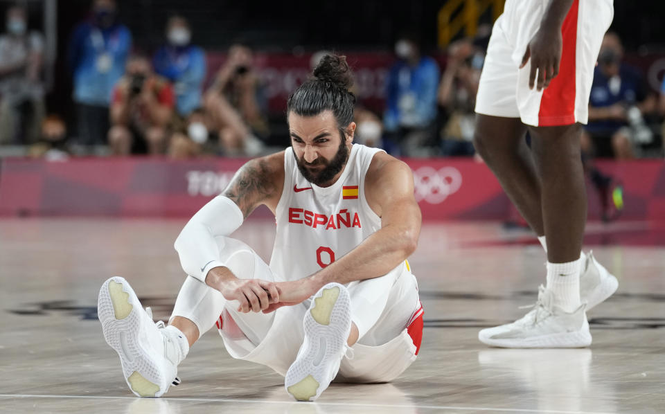 Spain's Ricky Rubio (9) reacts after he fell on the court during men's basketball quarterfinal game against United States of America at the 2020 Summer Olympics, Tuesday, Aug. 3, 2021, in Saitama, Japan. (AP Photo/Eric Gay)