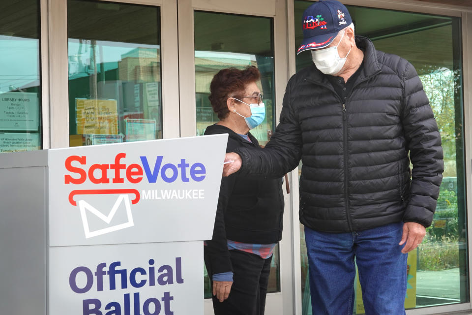 Residents drop mail-in ballots in an official ballot box outside of the Tippecanoe branch library on October 20, 2020 in Milwaukee, Wisconsin. (Scott Olson/Getty Images)