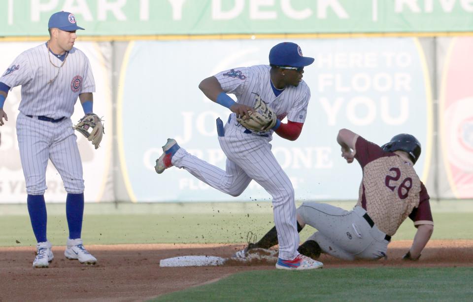 South Bend Cubs shortstop Jefferson Rojas (2) makes a [play at second on Wisconsin Timber Rattlers runner Luke Adams (28) Tuesday, April 9, 2024, at the South Bend Cubs home baseball opener against the Wisconsin Timber Rattlers at Four Winds Field in South Bend.