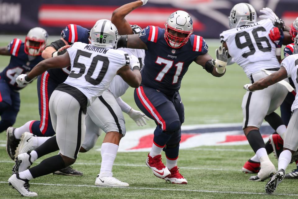 Patriots offensive lineman Michael Onwenu looks to block a Las Vegas Raiders defender during a September 2020 game in Foxboro.