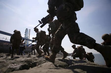 U.S. and South Korea marines land on a dock during a ceremony to mark the 65th anniversary of Incheon Landing Operations conducted by the U.S.-led United Nations troops during the 1950-1953 Korean War, in Incheon, South Korea, September 15, 2015. REUTERS/Kim Hong-Ji