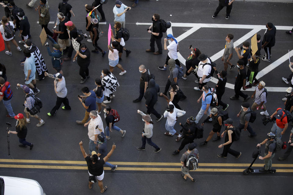 Demonstrators march outside the BOK Center where President Trump will hold a campaign rally in Tulsa, Okla., Saturday, June 20, 2020. (AP Photo/Charlie Riedel)