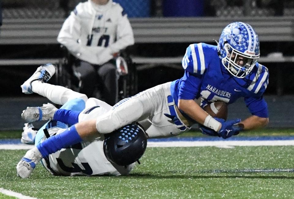 Gibraltar Carlson's Jackson Zachary surges forward for extra yards after a catch during Carson's 40-19 loss to Waterford Mott in the Division 2 Regional finals Friday night.