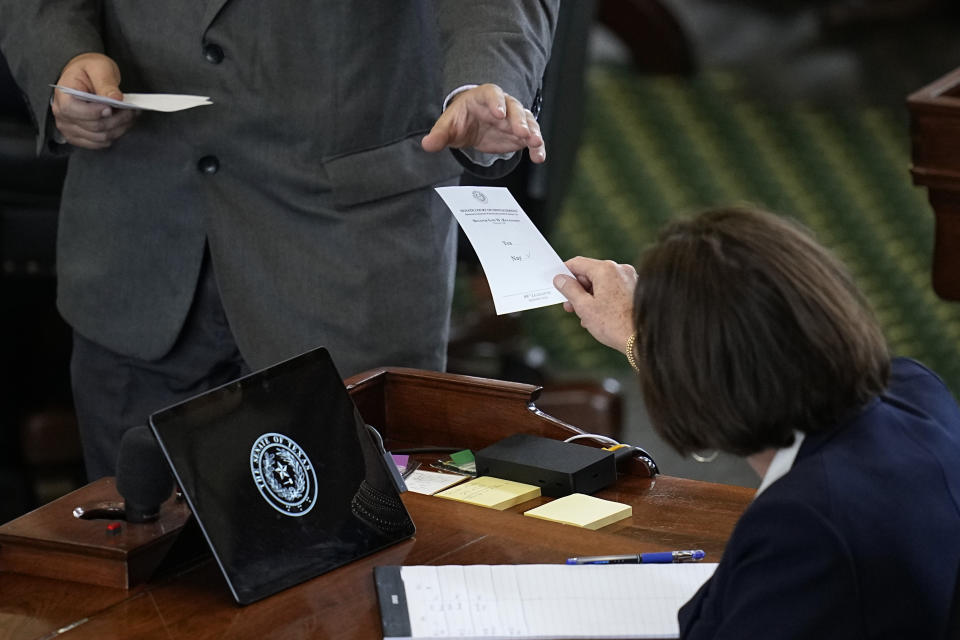 Texas state Sen. Lois Kolkhorst, right, acting as a juror votes on the articles of impeachment against suspended Texas Attorney General Ken Paxton in the Senate Chamber at the Texas Capitol, Saturday, Sept. 16, 2023, in Austin, Texas. (AP Photo/Eric Gay)