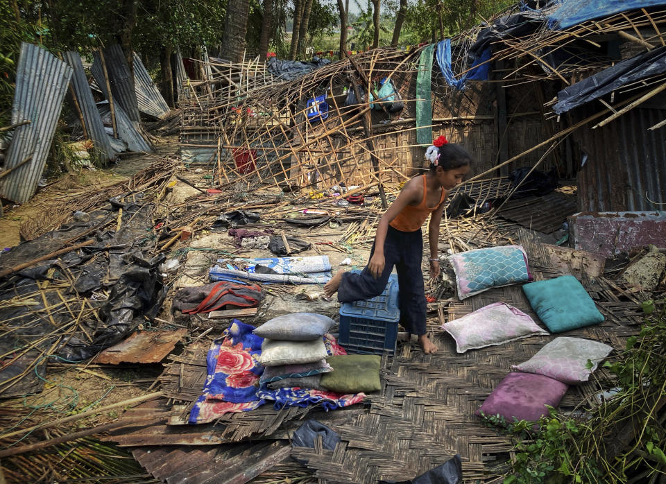 FILE- A child runs through the wreckage of her home damaged by Cyclone Mocha at Saint Martin island in Cox's Bazar, Bangladesh, Monday, May 15, 2023. Early warnings from weather agencies and preparedness by local governments and aid agencies likely saved thousands of lives from a power Cyclone in that might have been claimed by the cyclone that slammed into the joint coastline of Bangladesh and Myanmar on Sunday. But there are concerns over the large number of people still unaccounted for in regions where preventative action was lacking. (AP Photo/Al-emrun Garjon, File)