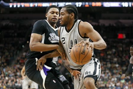 Mar 5, 2016; San Antonio, TX, USA; San Antonio Spurs small forward Kawhi Leonard (2) dribbles the ball against Sacramento Kings small forward Rudy Gay (8, left) during the first half at AT&T Center. Mandatory Credit: Soobum Im-USA TODAY Sports / Reuters Picture Supplied by Action Images